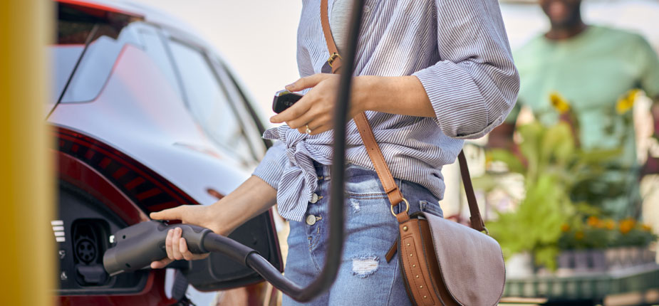 Woman charging with a public level 2 charger